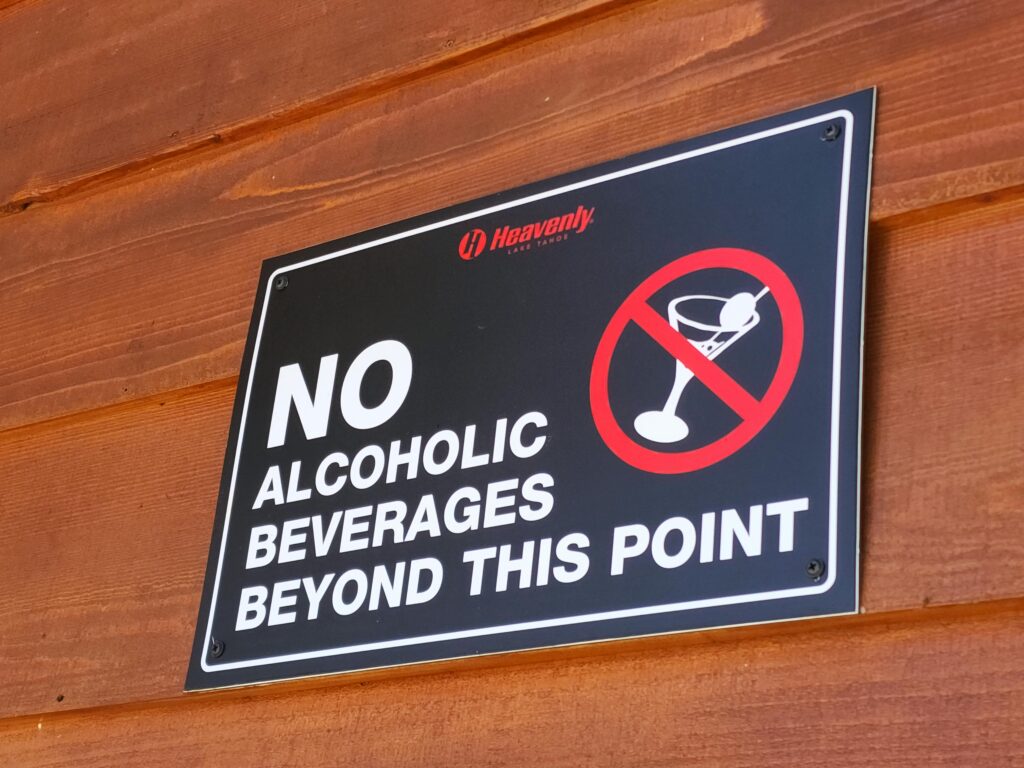 A warning sign prohibiting alcoholic beverages beyond this point at Heavenly Lake Tahoe.